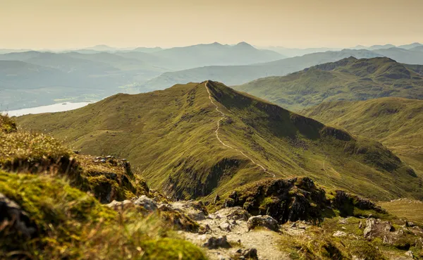 Ben Lawers and Beinn Ghlas hiking guide: 2-Munro route in Perthshire. 1,200m ascent, well-marked paths, and spectacular Loch Tay views. Perfect for intermediate hikers with stunning Highland scenery.